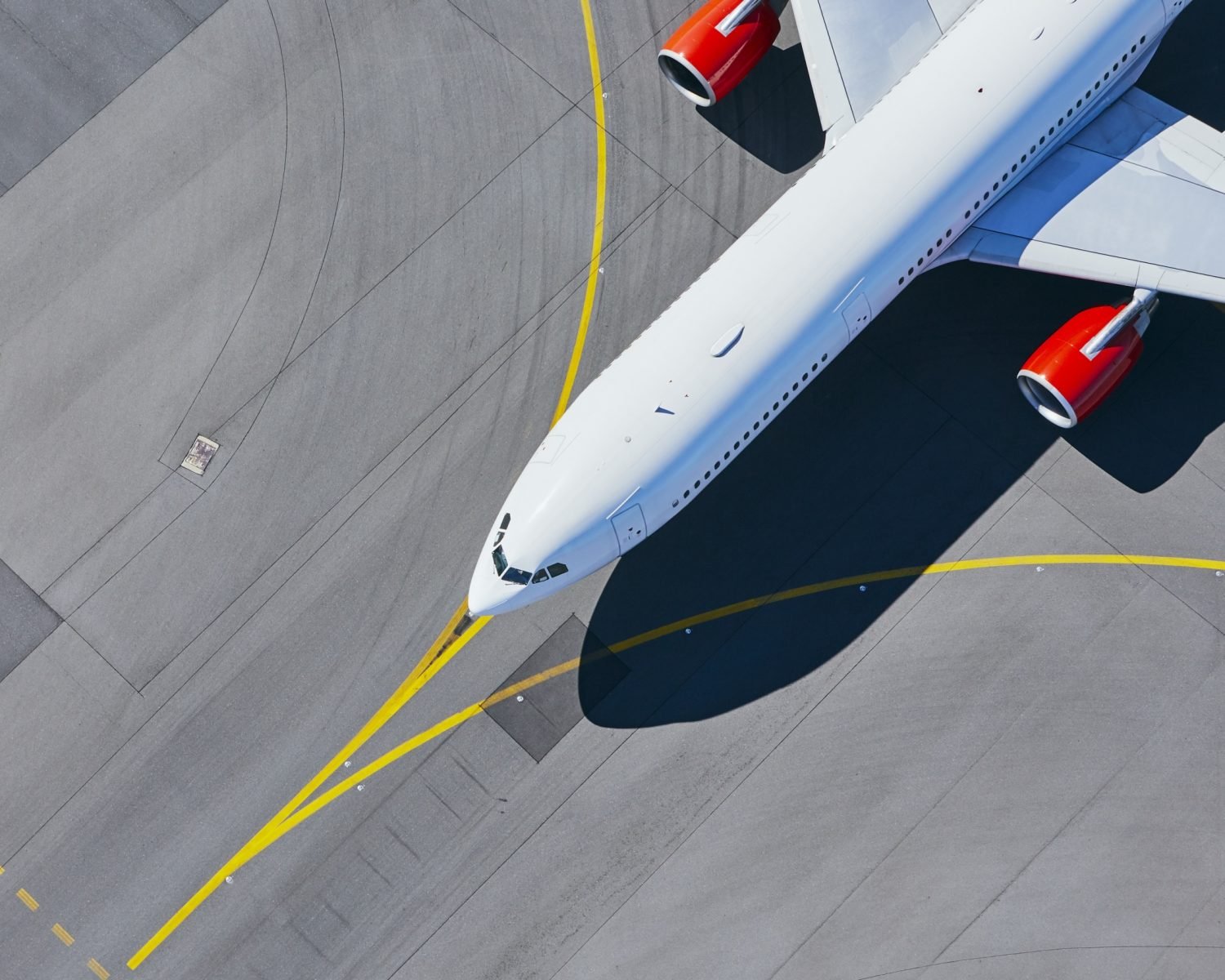 Aerial view of airport. Airplane taxiing to runway before take off.
